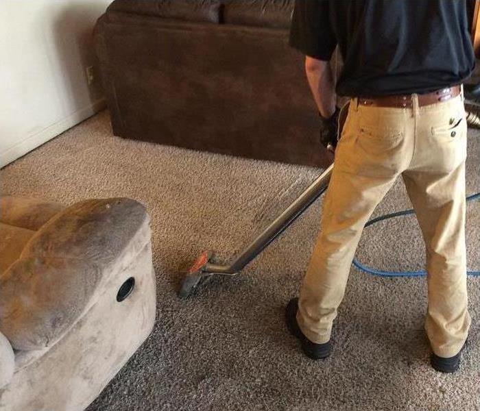 SERVPRO employee cleaning the carpet