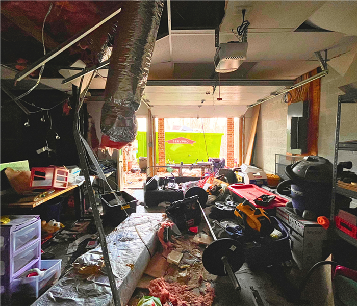 garage after fire, photo taken from back wall toward the open bay door